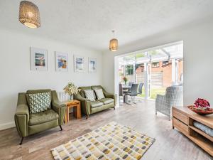 a living room with two chairs and a table at The Beach Bungalow in Beltinge