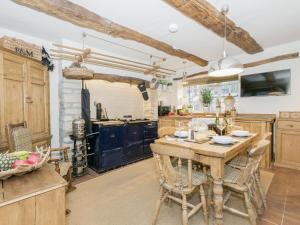 a large kitchen with a wooden table and chairs at Narrowgates Cottage in Barrowford +21 photos