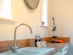 a kitchen counter top with a sink and a sink at Langford Villa in Filey