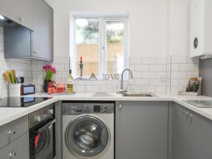 a kitchen with a washing machine and a sink at Apartment 1 - Uk42622 in Poole