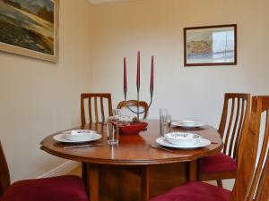 a wooden table with plates and bowls on it at Robinson in Keswick