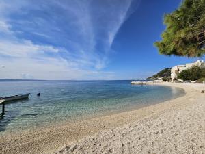 a sandy beach with a boat in the water at Nina in Split