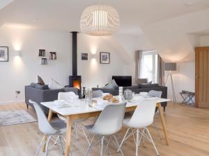 a dining room and living room with a table and chairs at Kenmore Lodge in Kenmore