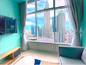 a room with a large window with a view of a city at Sky Suites KLCC By Elite Stay in Kuala Lumpur