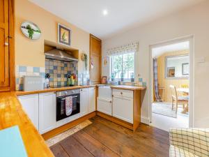 a kitchen with white cabinets and a counter top at Stamford Townhouse in Stamford +14 photos