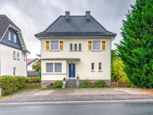 a white house with a black roof at Spacious Villa near Center in Medebach