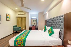 a bedroom with a large bed in a room at Treebo Comfy Business in Bengaluru +28 photos