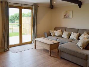 a living room with a couch and a coffee table at Horseshoe Cottage in Alkham