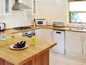 a kitchen with a plate of food on a counter at Family Lodge No 5 - Uk45694 in Moulin