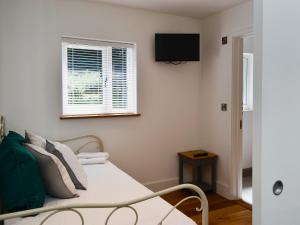 ein Schlafzimmer mit einem Bett und einem Fernseher an der Wand in der Unterkunft Hidden Gem in Berrynarbor