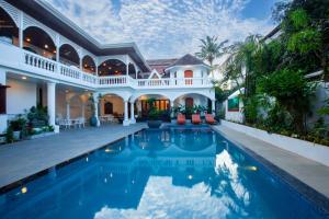 an exterior view of a house with a swimming pool at Villa Elixir Fort Kochi in Cochin