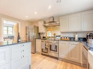 a kitchen with white cabinets and stainless steel appliances at Property 4 - Uk44924 in Wroxall