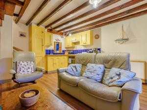 a living room with a couch and a kitchen at Sayers Yard in Whitby +19 photos