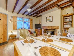 a dining room with a table with wine glasses on it at Sayers Yard in Whitby