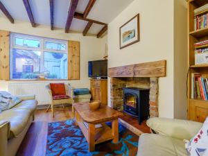 a living room with a couch and a fireplace at Sayers Yard in Whitby