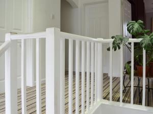 a white staircase with a potted plant on it at Heatherstone in Illogan