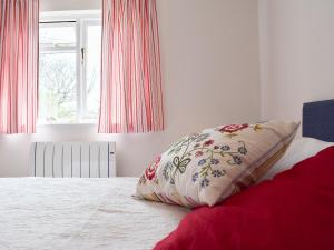 a pillow sitting on a bed in a bedroom at Stonecot in Wootton Bridge +7 photos