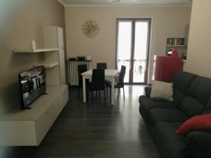 a living room with a couch and a table at Da Alessandro in Biella