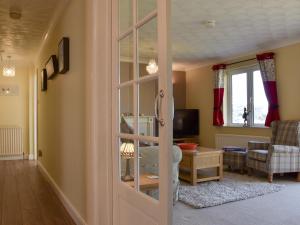 a living room with a sliding glass door at The Orchard in Bideford
