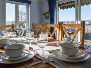a table with plates and glasses on top of it at The Orchard in Bideford