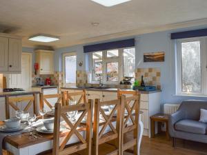 a kitchen and dining room with a table and chairs at The Orchard in Bideford