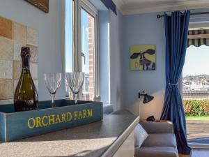 a room with a bottle of champagne and glasses on a counter at The Orchard in Bideford +24 photos