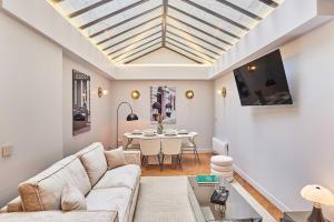 a living room with a couch and a table at Superb air-conditioned flat on the Champs Elysées in Paris