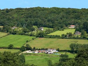 an aerial view of a house in a green field at The Dairy in Sidbury