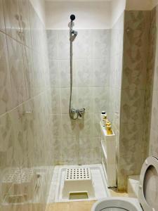 a bathroom with a shower and a toilet at Soman Gueliz Center Apartment in Marrakech +9 photos