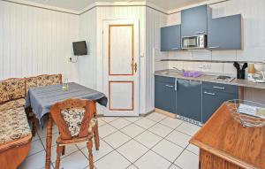 a kitchen with a table and a dining room at Fh Grün in Warenthin