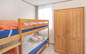 a bedroom with two bunk beds and a closet at Fh Grün in Warenthin +7 photos