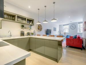 a kitchen with a counter and a living room at The Old Bank in Mundesley