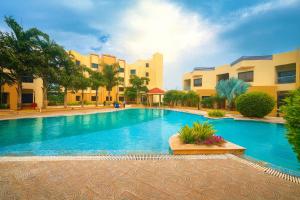 a large swimming pool in front of some buildings at The Sky Imperial Bapu's Resort, Dwarka in Dwarka