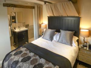 a bedroom with a large bed and a sink at The Old Explorers in Pateley Bridge