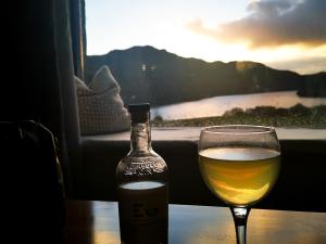 a glass of wine and a bottle on a table at The Grain Store in Aberarder +28 photos