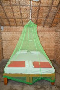 a bed in a tent in a room at Hampi Firangi Cafe in Hampi