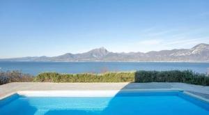 a swimming pool with a view of the water at Suite Incanto lago di Garda in Torri del Benaco