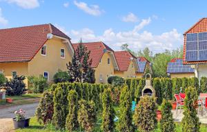 a row of houses with a hedge in a yard at Ferienhaus Verchen in Verchen +16 photos