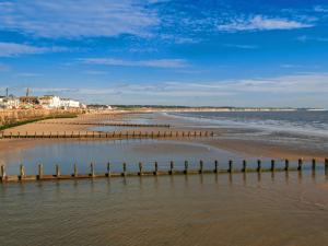 a beach with wooden posts in the water at Fisherman's Friend - Uk30742 in Bridlington +2 photos