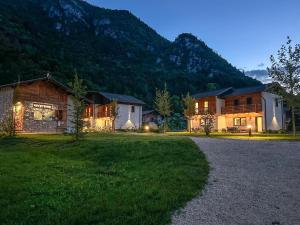 a group of buildings with a mountain in the background at Villaggio Azzurro in Pieve Di Ledro
