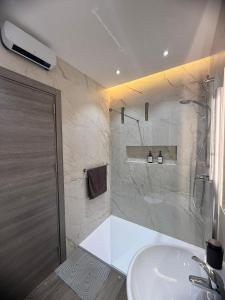 a bathroom with a shower and a white sink at Spielberg - Garage, Outdoor Area, Close to Beach in Marsaskala +39 photos