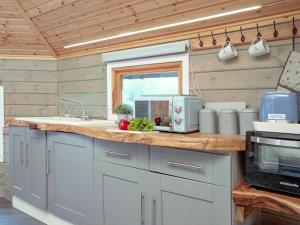 a kitchen with a counter top with a microwave at Mallard Roundhouse - Uk33891 in Cullompton +10 photos