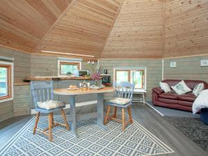 a living room with a table and chairs in a cabin at Mallard Roundhouse - Uk33891 in Cullompton