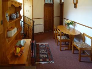 a room with a table with a bowl of fruit on it at Penfound Country Cottage in Poundstock