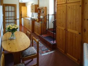a kitchen with a table with a vase of flowers on it at Penfound Country Cottage in Poundstock