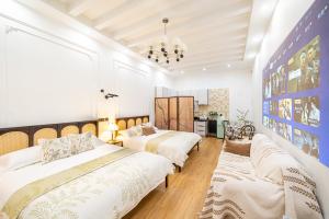 a bedroom with two beds and a chandelier at Tonight Homestay Jing'an Temple Shanghai Shenle Building in Shanghai