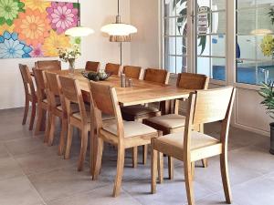 a wooden dining table and chairs in a room at 5 star holiday home in Væggerløse in Bøtø By