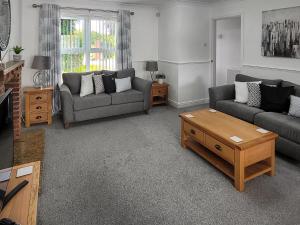 a living room with two couches and a coffee table at Askham House in York