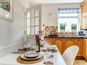 a kitchen with a table with glasses and a bottle of wine at Heughendon in Rothbury