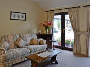 a living room with a couch and a table at Wee Cordorcan - Uk5890 in Bargrennan